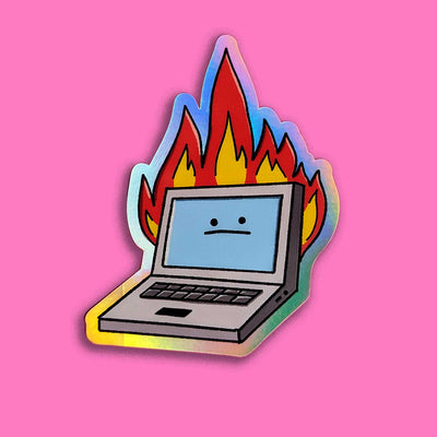 A holographic sticker featuring a cartoon laptop with a neutral facial expression engulfed in colorful flames, symbolizing a humorous take on technology issues. Pink background.