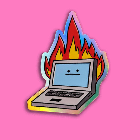A holographic sticker featuring a cartoon laptop with a neutral facial expression engulfed in colorful flames, symbolizing a humorous take on technology issues. Pink background.