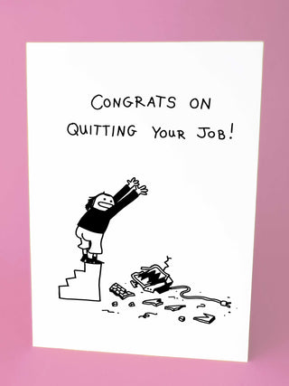 A humorous greeting card featuring a cartoon character standing on stairs with arms raised, celebrating quitting their job. The card reads 'Congrats on Quitting Your Job!' with a broken computer at the bottom of the stairs.