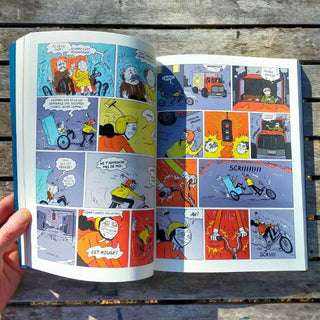 Open comic book with colorful panels on a wooden surface
