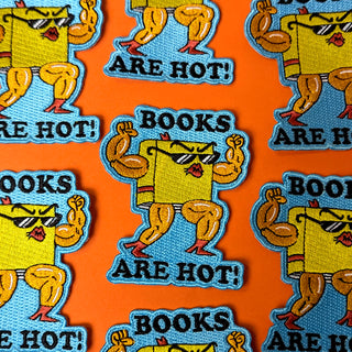 A collection of bold iron-on patches featuring a muscular book and the playful text 'Books are hot!' – perfect for bookworms who want to make a fun and stylish statement!"