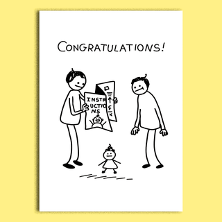 A white rectangular greeting card with a black hand-drawn cartoon showing two adults, a child, and the word 'CONGRATULATIONS!' at the top, displayed against a pale yellow background.