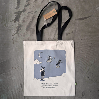 Tote bag with a printed design of three witches on a gray surface