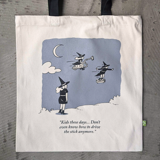 Tote bag with cartoon design of witches and a humorous quote on a gray background