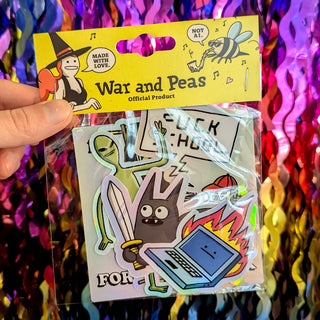 A vibrant yellow War and Peas Surprise Sticker Pack held in hand, featuring six holographic, dark humor stickers sealed in a reusable plastic bag. The pack includes funny designs like a flaming laptop, a sword-wielding cat, and a robot with a ‘FUCK SCHOOL’ sign. Perfect for fans of quirky, hand-drawn art. Each sticker is waterproof, durable, and made with love (as the tag says!).