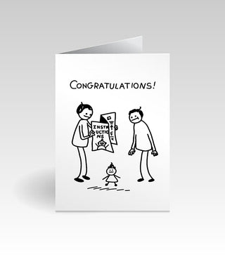 A folded white greeting card shown standing upright on a light gray background. The front has black line-art stick figures and the word 'CONGRATULATIONS!' at the top, with a small illustration below.